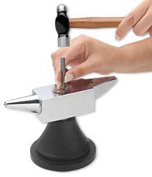 metal being stamped on an anvil